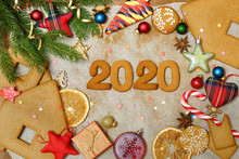 Christmas Background With Gingerbread. Christmas Toys, Cookies And Candy On Paper. The Inscription 2020.