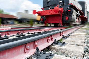 rails for trains close-up selective focus, against the background of the train coming towards, safety on the railway, the danger of railway crossings