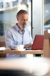 © Westend61 - mature, man using laptop in a cafe