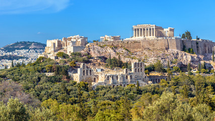 Wall Mural - Acropolis of Athens in summer, Greece. View of famous Parthenon and Odeon of Herodes. Urban landscape of old Athens with classical Greek ruins. Scenic panorama of remains of ancient Athens city.