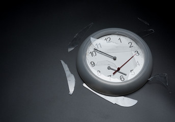 Broken wall clock on dark background,destroyed clock