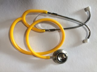 yellow stethoscope on white background