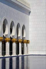 Wall Mural - marble white and gold collonade around water and walls of grand mosque in sun light