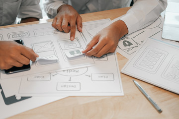user experience ux designer designing web on smart phone layout. ui developer planning working on mo