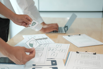 user experience UX designer designing web on smart phone layout. UI developer planning working on mobile application prototype