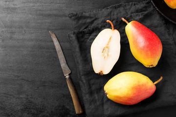 Wall Mural - Fresh ripe organic pears on a black wooden table