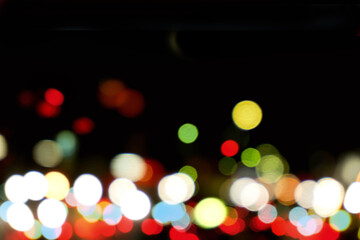 Wall Mural - Abstract colorful bokeh and blurred reflection lighting on black background