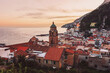 Beautiful view of the cathedral and the city of Amalfi with colorful houses at sunset. Amalfi evening panorama with sunset and sea views. Amalfi Coast, Italy