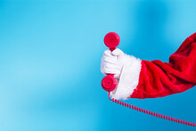 Santa Claus Hand Holding Red Phone With Christmas Greeting
