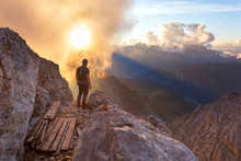 A Hiker Oberves A Cloudy Sunset From The Summit Of Cima Di Costabella, Costabella Ridge, Marmolada Group, Dolomites, Moena, Fassa Valley, Trento Province, Trentino-Alto Adige, Italy.