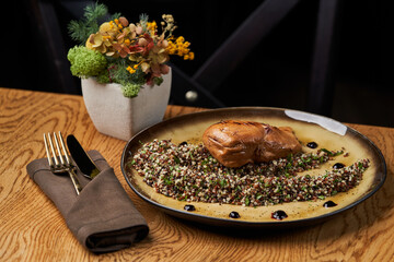 Roasted chicken breast on plate on wooden table background