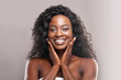 © Prostock-studio - Beautiful african american woman touching her smooth skin on cheeks