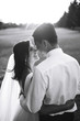 © maxbelchenko - Black and white photo of cheerful emotional newlyweds who enjoy each other. Gorgeous bride and handsome groom. Luxury elegant wedding couple kissing and embracing. Romantic moment.Together. Wedding.
