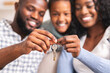 © Prostock-studio - Happy african american family holding keys from their new home