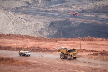 Big yellow mining truck and bulldozer at work industry site