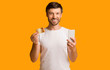 © Prostock-studio - Man Holding Phone And Credit Card Smiling At Camera, Studio