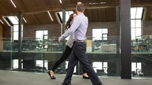 Business Man & Woman Filmed In Bullet Time Giving A High 5 As They Pass In The Office