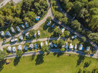 aerial view of campground in rural area in europe with many caravans. concept of adventure and outdo