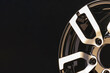 item spokes close-up aluminum die-cast alloy wheel for powerful SUV close-up on black background. polished surface. copyspace left.