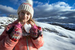 girl holds in her hands a heart of snow