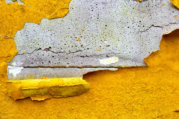 Wall Mural - concrete wall with yellow, orange peeling paint old cracked damaged rough bright background texture