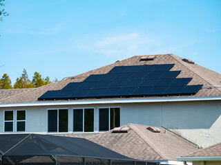 Solar panel on a house roof; Green energy from sun	