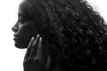 Close Up Portrait Of An Attractive Dark Skinned Woman With Long Hair And Strong Features, Black And White