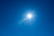 Sun, Sunbeams Against Blue Sky - Cloudless Heaven. Photography With Lense Flair Effect