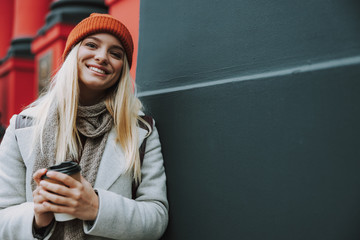 Wall Mural - Young woman with coffee to go in hands