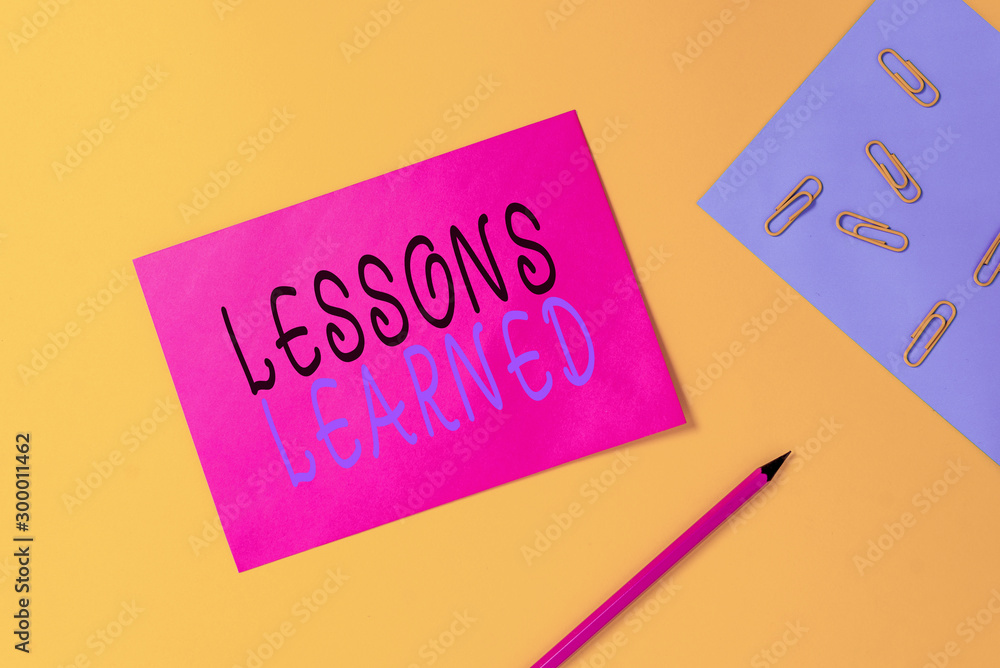 Writing note showing Lessons Learned. Business concept for experiences ...