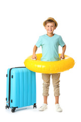 Poster - Cute little boy with suitcase and swimming ring on white background