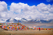 Tibetan Praying Flags Against The Himalaya Mountains Covered By Snow, Against A Blue Clear Sky.