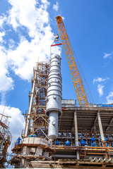 MOSCOW, RUSSIA, 08.2018: Construction of an oil refinery near Moscow. Workers install components of an oil refinery, construction and installation of components of an oil refinery in the suburbs.