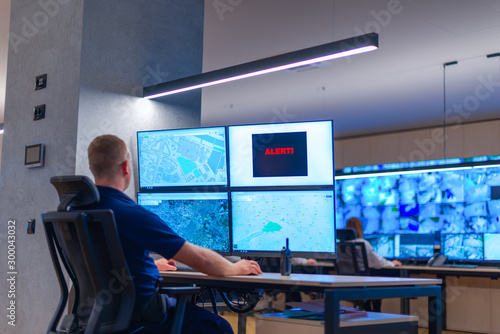 Fotografía Male computer operator monitoring from a security ( computer, logistic ) center