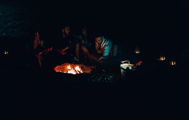 Group of happy friends with guitar having fun outdoor