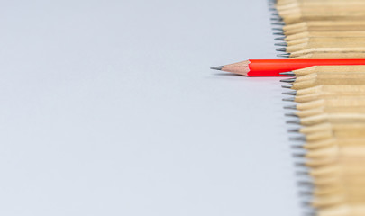 different pencil standout from the others showing concept of unique business thinking different from