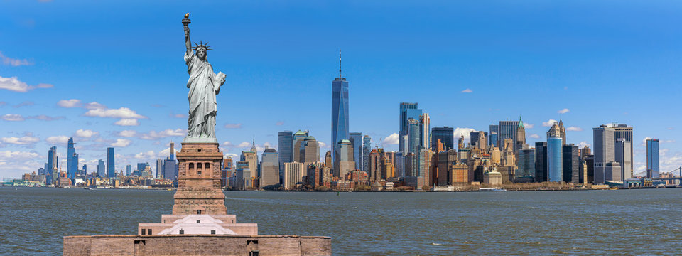the statue of liberty over the panorama scene of new york cityscape river side which location is low