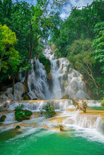 Kuang Si Falls Near To Popular Travel Destination Luang Prabang In Laos. Three Level Waterfall With Turquoise Blue Pools Surrounded With Lush Green Tropical Jungle.