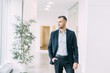© pavelvozmischev - Walking around the business center. Portrait of a young successful man in motion.
