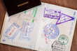 © Arthur - Stamps in a passport, travel life background
