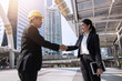 © khwanchai - engineer shake hand with building contractor for construction concept banner