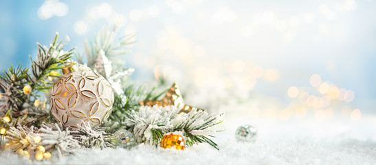 Wall Mural - christmas winter background with christmas baubles and fir tree branches on snow.