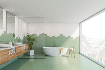 green and white tile bathroom, tub and sink