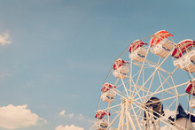 Ferris Wheel On Cloudy Sky Background With Vintage Toned.