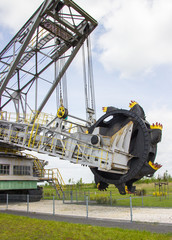 Opencast brown coal mine. Excavator SchRs-315. Extractive industry.