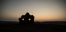 Military Patrol Car On Sunset Background. Army War Concept. Silhouette Of Armored Vehicle With Soldiers Ready To Attack. Artwork Decoration. Selective Focus