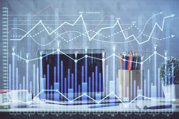 Financial chart drawing and table with computer on background. Double exposure. Concept of international markets.