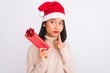 © Krakenimages.com - Young chinese cleaner woman wearing gloves holding mop over isolated white background serious face thinking about question, very confused idea