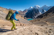 Girl hiking Huayhuash circuit, Santa Rosa pass with epic view to Siula Grande peak, Huayhuash range, Huaraz, Ancash, Peru