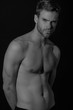 © Oleh Phoenix - Black and White Strong stripped muscle male model in black underwear on black isolated font background
